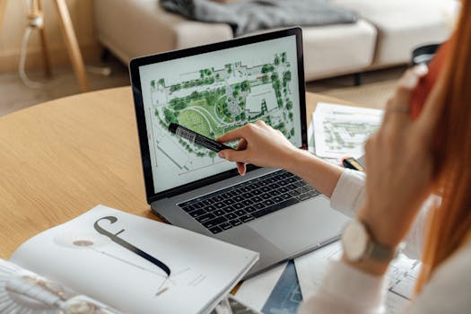 Architect reviewing landscape design on laptop, enhancing architectural projects from home office.