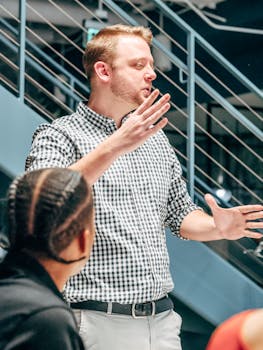 Businessman leading a team meeting, engaging in dynamic discussion with colleagues.