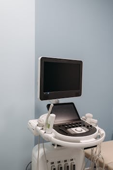 Digital ultrasound machine with monitor in a healthcare setting, illustrating advanced medical technology.