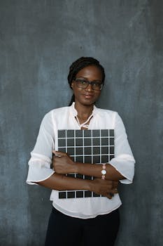 Professional woman standing with a grid board against a textured background.